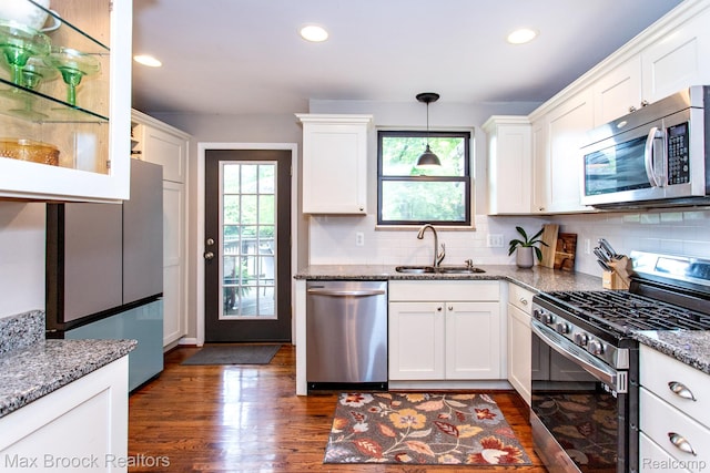 13317 Victoria Ave, Huntington Woods, MI 48070 - kitchen featuring stainless steel appliances, a sink, dark wood finished floors, white cabinets, and tasteful backsplash