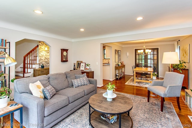 13317 Victoria Ave, Huntington Woods, MI 48070 - living area featuring a chandelier, wood finished floors, stairs, recessed lighting, and arched walkways