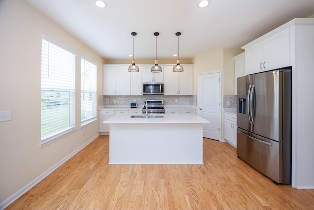 4301 Rolling Meadow Ln, Ypsilanti, MI 48197 - kitchen featuring appliances with stainless steel finishes, light countertops, decorative backsplash, white cabinets, and recessed lighting