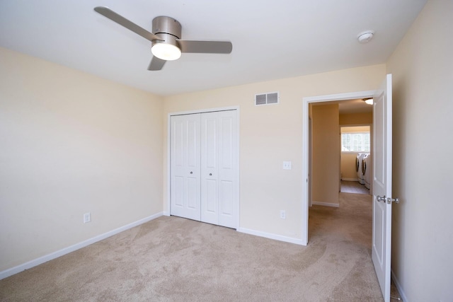 4301 Rolling Meadow Ln, Ypsilanti, MI 48197 - unfurnished bedroom featuring carpet flooring, baseboards, a closet, and washer / clothes dryer