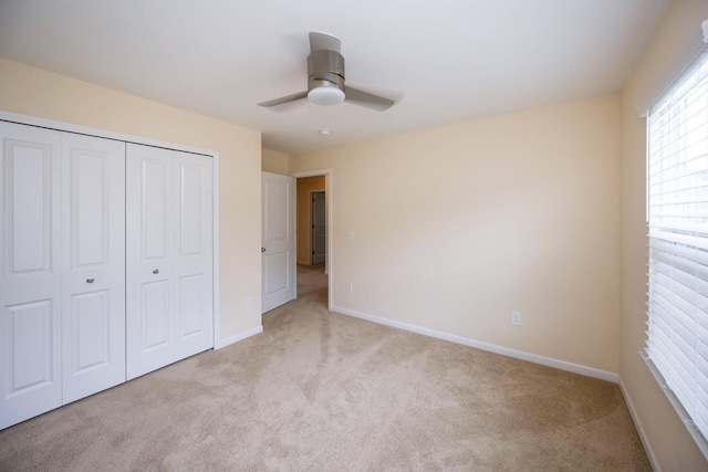 4301 Rolling Meadow Ln, Ypsilanti, MI 48197 - unfurnished bedroom with light carpet, a closet, baseboards, and ceiling fan