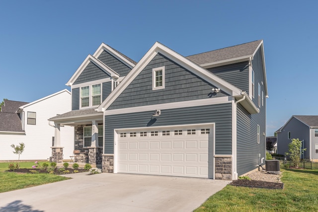 4301 Rolling Meadow Ln, Ypsilanti, MI 48197 - craftsman inspired home with stone siding, central AC unit, concrete driveway, and covered porch