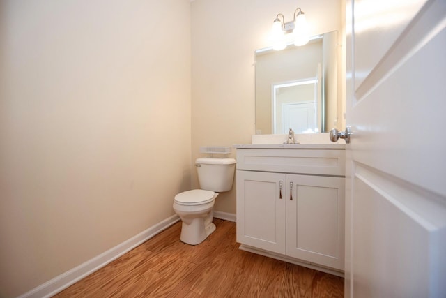 4301 Rolling Meadow Ln, Ypsilanti, MI 48197 - bathroom with wood finished floors, toilet, vanity, and baseboards