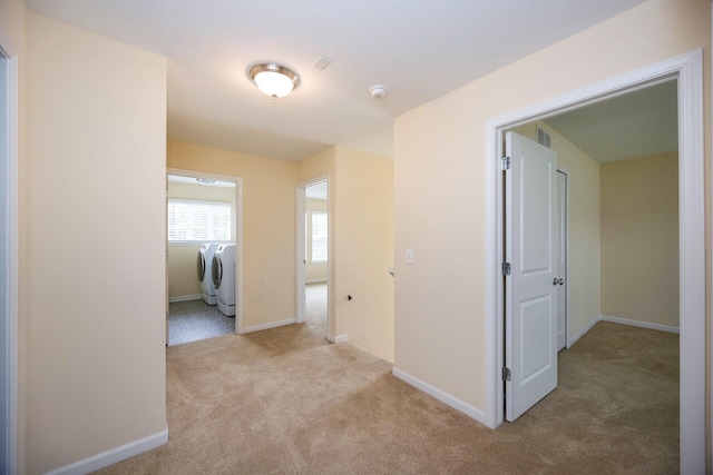 4301 Rolling Meadow Ln, Ypsilanti, MI 48197 - corridor with washing machine and dryer, carpet flooring, and baseboards