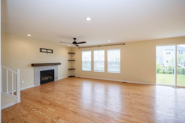 4301 Rolling Meadow Ln, Ypsilanti, MI 48197 - unfurnished living room featuring a ceiling fan, light wood-style floors, a fireplace, healthy amount of natural light, and recessed lighting