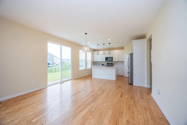 4301 Rolling Meadow Ln, Ypsilanti, MI 48197 - unfurnished living room with light wood finished floors, a chandelier, baseboards, and recessed lighting