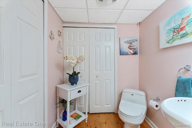 28395 Swan Island Dr, Grosse Ile, MI 48138 - bathroom with a paneled ceiling, wood finished floors, toilet, and a closet