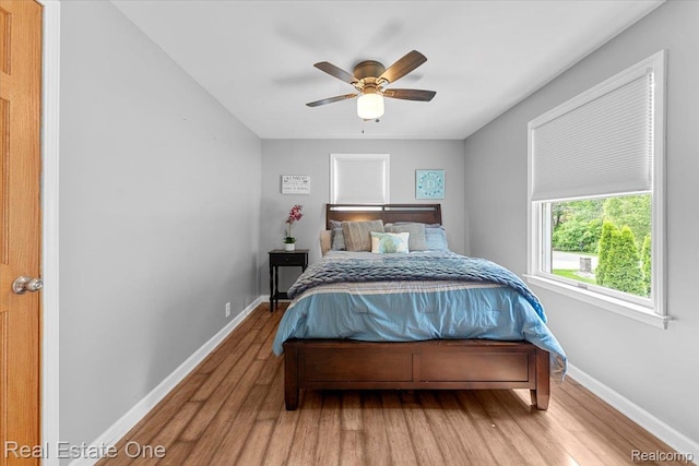 28395 Swan Island Dr, Grosse Ile, MI 48138 - bedroom featuring wood finished floors, baseboards, and a ceiling fan