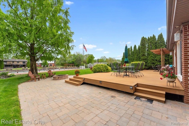 28395 Swan Island Dr, Grosse Ile, MI 48138 - view of patio featuring an outdoor fire pit, a wooden deck, and outdoor dining area