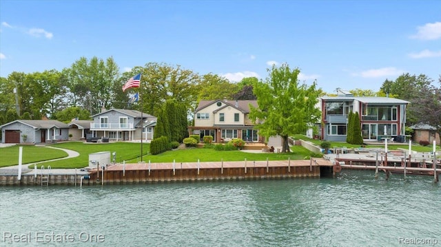 28395 Swan Island Dr, Grosse Ile, MI 48138 - back of property featuring a water view and a lawn