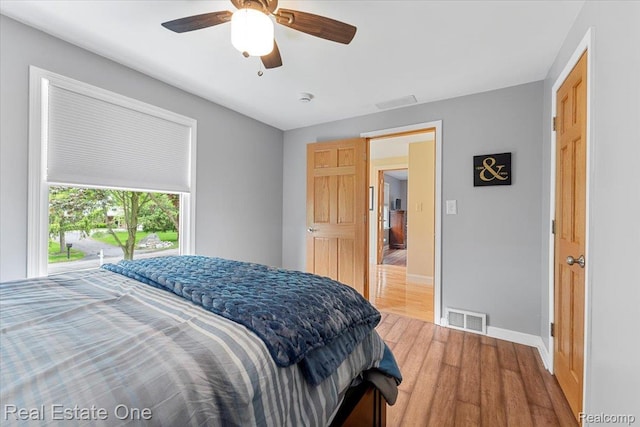 28395 Swan Island Dr, Grosse Ile, MI 48138 - bedroom featuring wood finished floors, baseboards, and ceiling fan