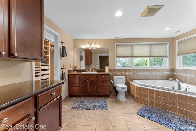 28395 Swan Island Dr, Grosse Ile, MI 48138 - bathroom featuring vanity, toilet, a garden tub, and tile patterned floors
