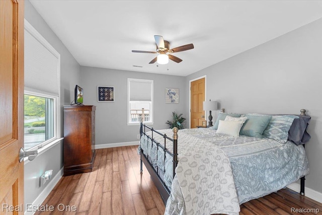 28395 Swan Island Dr, Grosse Ile, MI 48138 - bedroom with baseboards, wood finished floors, and a ceiling fan