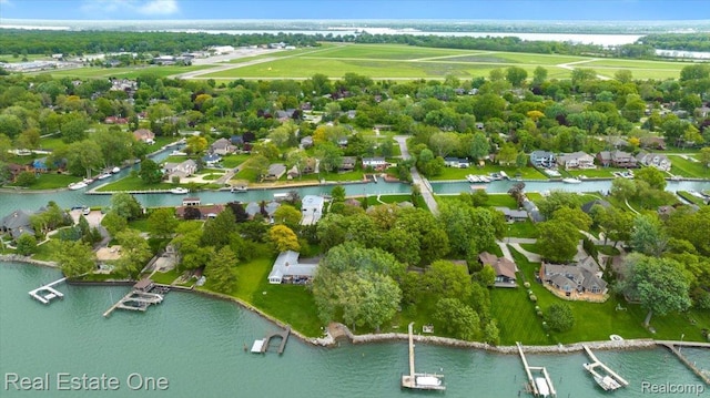 28395 Swan Island Dr, Grosse Ile, MI 48138 - aerial perspective of suburban area featuring a nearby body of water and a tree filled landscape