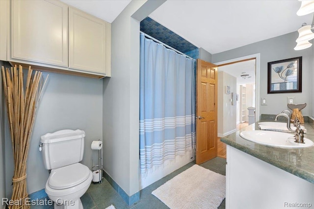 28395 Swan Island Dr, Grosse Ile, MI 48138 - bathroom with toilet, double vanity, baseboards, and tile patterned floors