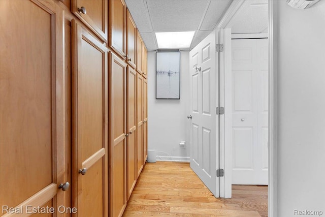 28395 Swan Island Dr, Grosse Ile, MI 48138 - hallway with light wood finished floors, a drop ceiling, and baseboards