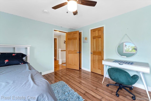 28395 Swan Island Dr, Grosse Ile, MI 48138 - bedroom with wood finished floors, baseboards, and ceiling fan