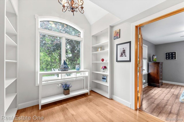 28395 Swan Island Dr, Grosse Ile, MI 48138 - hall featuring wood finished floors, a chandelier, and healthy amount of natural light