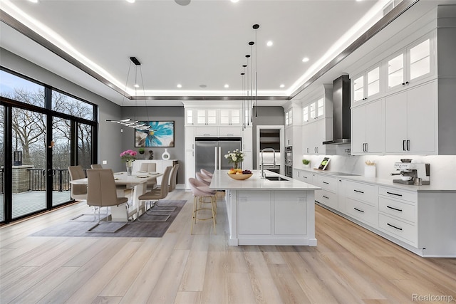 1760 Vista Dr, Oakland, MI 48363 - kitchen with a sink, a raised ceiling, light countertops, wall chimney range hood, and stainless steel appliances