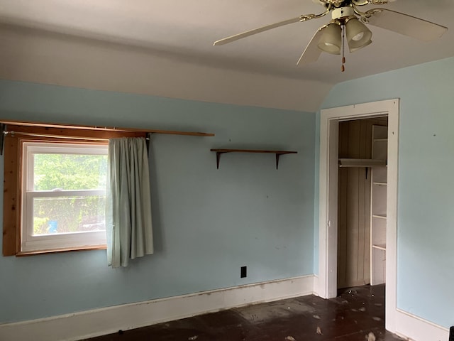 821 Fletcher St, Owosso, MI 48867 - unfurnished bedroom featuring lofted ceiling, a closet, a ceiling fan, baseboards, and unfinished concrete flooring