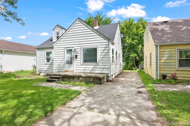 29056 Powers St, Westland, MI 48186 - view of front facade with a front lawn, a chimney, and roof with shingles