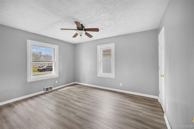 29056 Powers St, Westland, MI 48186 - empty room with a ceiling fan, a textured ceiling, wood finished floors, and baseboards