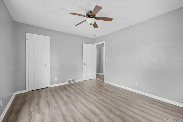 29056 Powers St, Westland, MI 48186 - unfurnished bedroom featuring wood finished floors, baseboards, a textured ceiling, and a ceiling fan