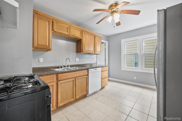 29056 Powers St, Westland, MI 48186 - kitchen featuring white dishwasher, black gas range oven, freestanding refrigerator, a sink, and dark countertops