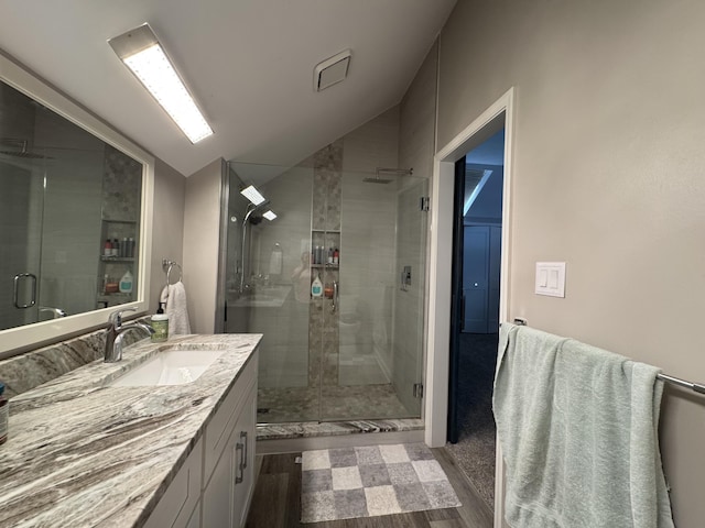 1300 Winding Ridge Ln Unit D8, Indiana, IN 46383 - bathroom with vaulted ceiling, vanity, a stall shower, and wood finished floors