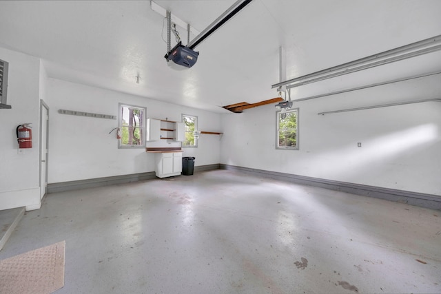 8750 20th Ave, Remus, MI 49340 - garage featuring a garage door opener and baseboards