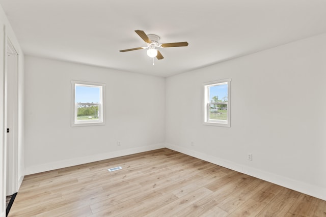 4565 155th Ave, Hersey, MI 49639 - unfurnished bedroom with multiple windows, light wood-type flooring, and baseboards