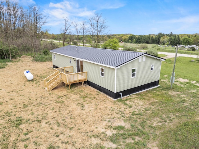 4565 155th Ave, Hersey, MI 49639 - rear view of property featuring a deck, metal roof, and a lawn