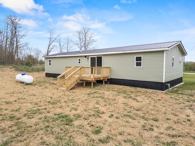 4565 155th Ave, Hersey, MI 49639 - back of house with a wooden deck, metal roof, and a yard