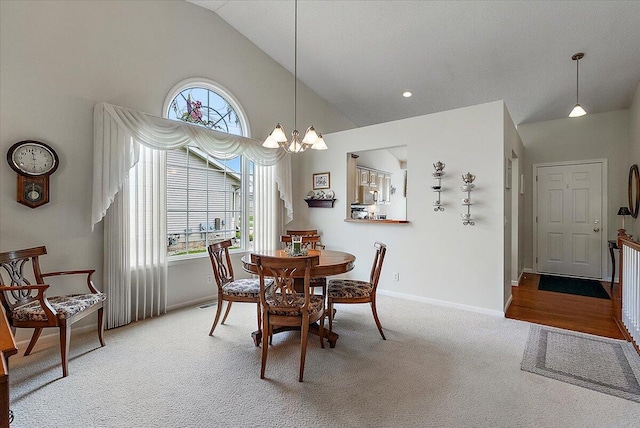 3799 Fairway Dr, Norton Shores, MI 49441 - dining room with carpet, baseboards, a chandelier, and high vaulted ceiling