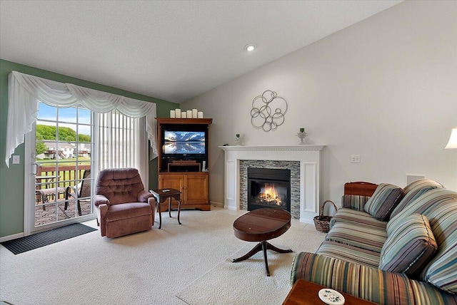 3799 Fairway Dr, Norton Shores, MI 49441 - carpeted living area with lofted ceiling, a stone fireplace, and baseboards
