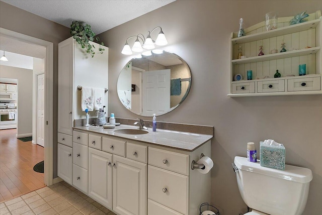 3799 Fairway Dr, Norton Shores, MI 49441 - bathroom with toilet, vanity, and tile patterned floors
