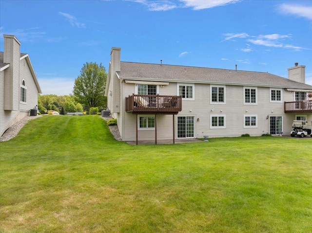 3799 Fairway Dr, Norton Shores, MI 49441 - rear view of house featuring a chimney, a lawn, cooling unit, and a deck