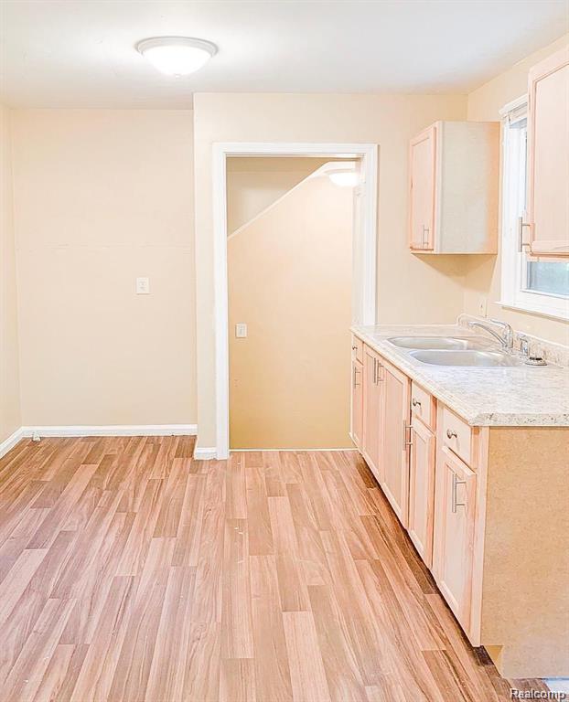 18220 Stout St, Detroit, MI 48219 - kitchen featuring a sink, light countertops, and light wood-style flooring