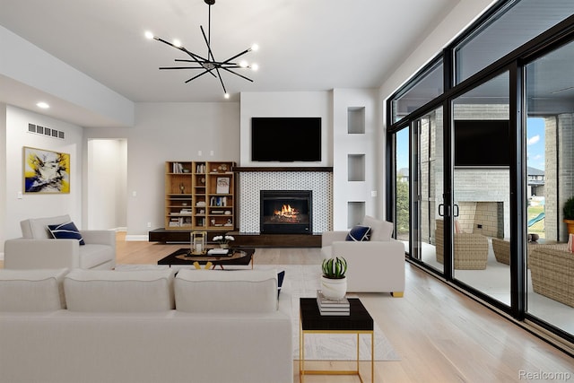 1792 Vista Dr, Oakland, MI 48363 - living room with a fireplace, light wood-type flooring, plenty of natural light, a chandelier, and recessed lighting