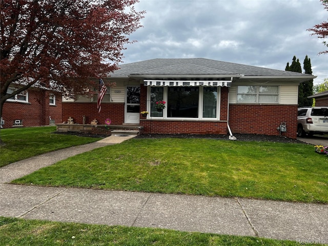 3125 Syckelmoore St, Trenton, MI 48183 - bungalow-style home featuring brick siding, a front lawn, and roof with shingles