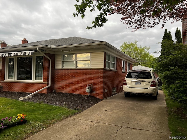 3125 Syckelmoore St, Trenton, MI 48183 - view of home's exterior with brick siding, concrete driveway, a chimney, and roof with shingles