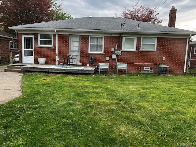 3125 Syckelmoore St, Trenton, MI 48183 - back of house featuring a chimney, brick siding, a deck, and a lawn