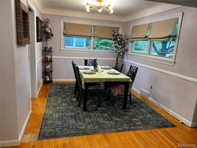 3125 Syckelmoore St, Trenton, MI 48183 - dining area featuring a chandelier, wood finished floors, and baseboards