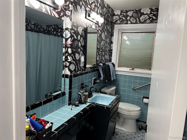 3125 Syckelmoore St, Trenton, MI 48183 - full bathroom with wallpapered walls, toilet, vanity, wainscoting, and tile walls