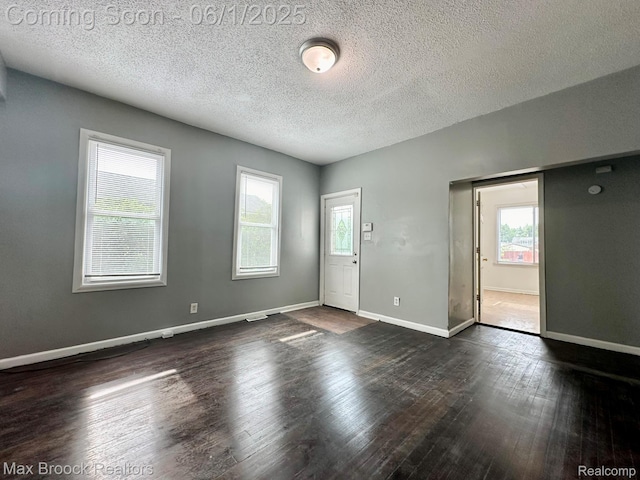7584 Jackson Ave, Warren, MI 48091 - spare room with plenty of natural light, dark wood-type flooring, a textured ceiling, and baseboards
