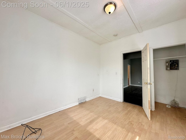 7584 Jackson Ave, Warren, MI 48091 - unfurnished bedroom with light wood-type flooring, a closet, a textured ceiling, and baseboards
