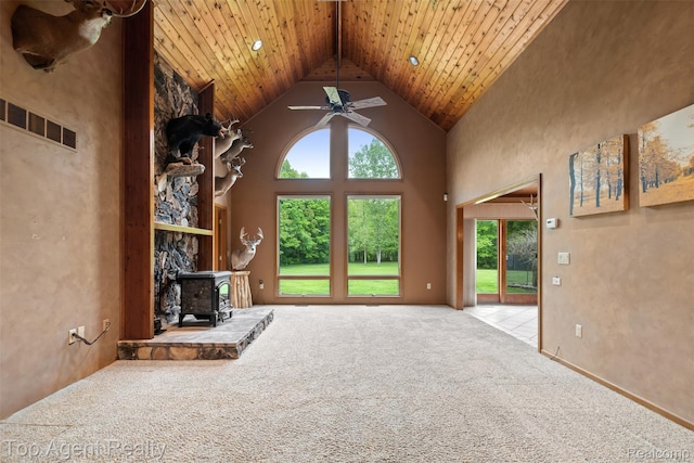 7386 Card Rd, Smiths Creek, MI 48074 - unfurnished living room featuring plenty of natural light, carpet flooring, high vaulted ceiling, a wood stove, and ceiling fan