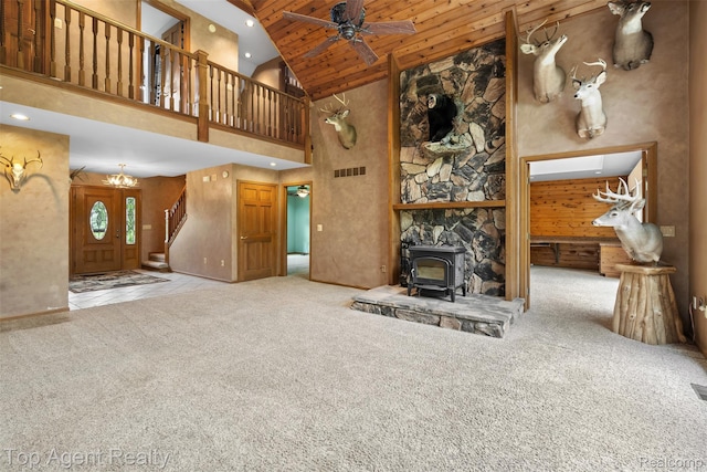 7386 Card Rd, Smiths Creek, MI 48074 - unfurnished living room featuring a wood stove, high vaulted ceiling, carpet floors, stairway, and a ceiling fan