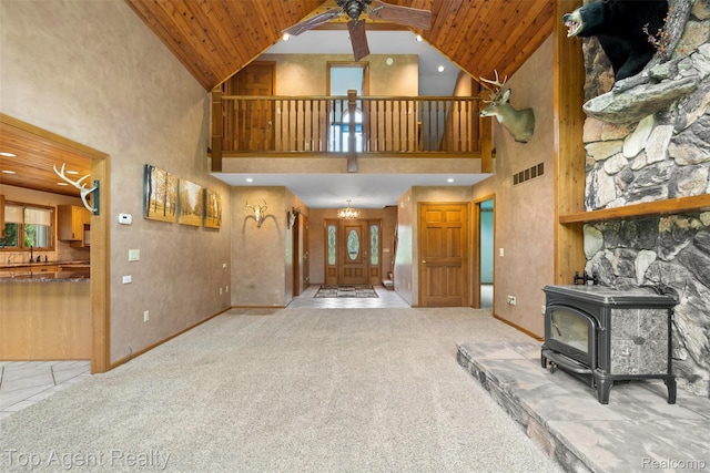 7386 Card Rd, Smiths Creek, MI 48074 - unfurnished living room featuring a wood stove, ceiling fan, wooden ceiling, high vaulted ceiling, and a sink