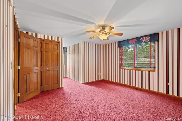 7386 Card Rd, Smiths Creek, MI 48074 - unfurnished bedroom featuring wallpapered walls, carpet, and a ceiling fan